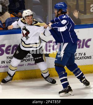 Wilkes-Barre/Scranton Penguins' Bobby Farnham, left, fights with Portland  Pirates' Brett Hextall as Penguins mascot Tux watches from the stands  during an AHL hockey game Friday, Feb. 7, 2014, at Mohegan Sun Arena