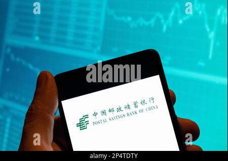 China. 19th Feb, 2023. In this photo illustration, the Chinese commercial retail bank Postal Savings Bank of China (PSBC) logo is seen displayed on a smartphone with an economic stock exchange index graph in the background. Credit: SOPA Images Limited/Alamy Live News Stock Photo