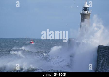 Waves crash over the Tynemouth pier lighthouse at the mouth of the river Tyne in North East England. Picture date: Monday March 6, 2023. Stock Photo