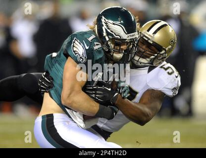 New Philadelphia Eagles' wide receiver Gary Ballman (85) goes down under  onslaught of New York Giants' safety Spider Lockhart (43) as the Giants'  defense man broke up a pass attempt in first