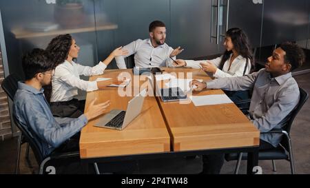Office meeting briefing diverse staff members team workers colleagues managers sit at table in modern boardroom discuss project. Businesspeople Stock Photo