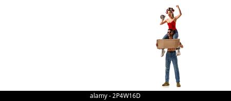 Young man and woman emotionally shouting in megaphone over white background. Protest and demonstration. Stock Photo