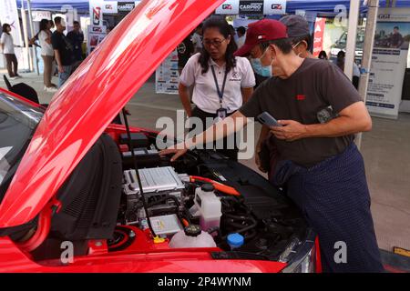 Yangon, Myanmar. 2nd Mar, 2023. Visitors look at a BYD e2 battery electric car imported from China at the Pannita Auto Fair in Yangon, Myanmar, March 2, 2023. Myanmar has imported the first batch of Chinese-made battery electric vehicles (BEVs) in January in implementing its one-year pilot EV project. TO GO WITH 'Roundup: Myanmar imports Chinese battery electric vehicles for pilot project' Credit: Myo Kyaw Soe/Xinhua/Alamy Live News Stock Photo