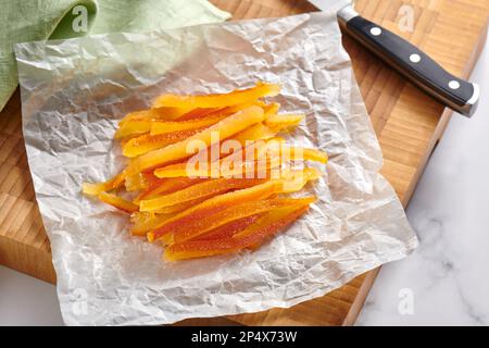 Candied orange peels on wrinkled baking paper Stock Photo