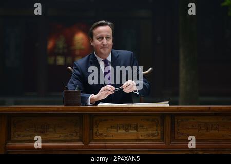 British Prime Minister David Cameron visits the Du Fu Thatched Cottage in Chengdu in southwest China's Sichuan province on Wednesday, Dec. 4, 2013.(Photo By Zhang Lang/Color China Photo/AP Images)