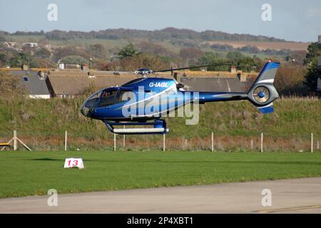 A Eurocopter EC 120B Colibri helicopter departs Brighton City Airport Stock Photo