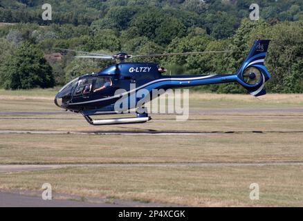 A Eurocopter EC 120B Colibri helicopter departs from Redhill Aerodrome Surrey Stock Photo