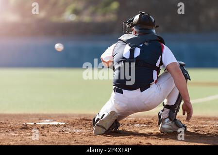 Baseball catcher during game, baseball catcher reaching to catch ball Stock Photo