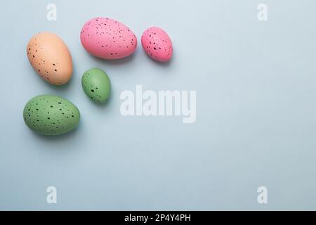 Frame from multicolored eggs on blue background.Easter concept. Stock Photo