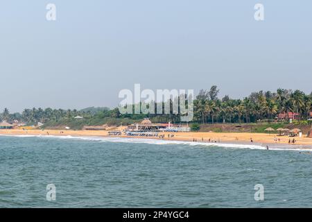 Candolim, Goa, India - January 2023: A view of the beautiful beach lined with coconut trees in Sinquerim. Stock Photo