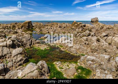 Rock Pool and Scenic Sea Low Tide View at Greencliff Beach With, Exposed Rocks, Rock Pools, Looking To Lundy Island: Greencliff, Near Bideford Stock Photo