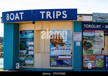 Colourful Detail of a Boat Trip Booking Hut on Torquay Sea Front with Posters Advertising Available Services. Stock Photo