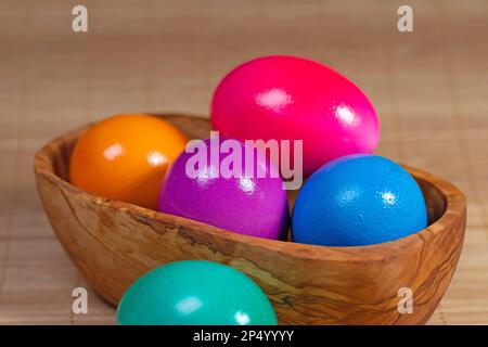 Colorful chicken eggs in a wooden bowl Stock Photo