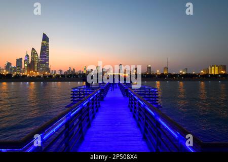 Skyline of Kuwait City at sunset with pier Stock Photo - Alamy