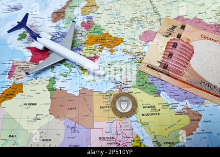 Manama, Kingdom of Bahrain - February 19 2019: Composition made of a world map centered in Middle East with on it, a Bahraini dinar banknote, a coin a Stock Photo