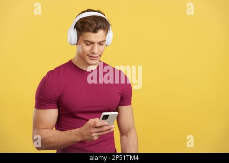 Relaxed man listening to music with the mobile and headphones Stock Photo