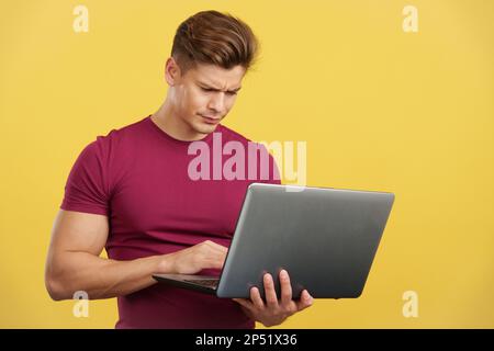 Strong man having a problem while using a laptop Stock Photo