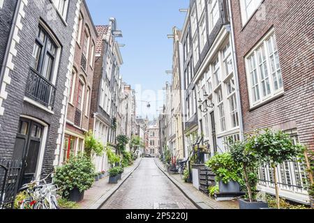 Amsterdam, Netherlands - 10 April, 2021: a woman sitting at a table in ...