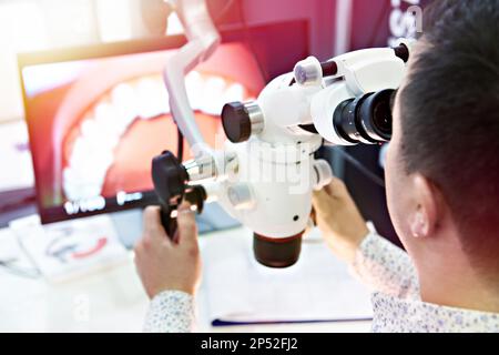 Dental surgery microscope and doctor Stock Photo