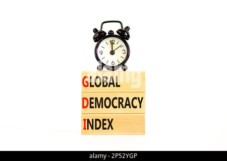 GDI global democracy index symbol. Concept words GDI global democracy index on wooden blocks on a beautiful white table white background. Business and Stock Photo