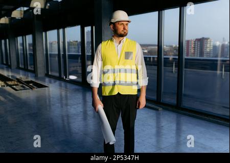 Portrait of an architect with construction drawings. contractor holding a roll of architectural projects Stock Photo