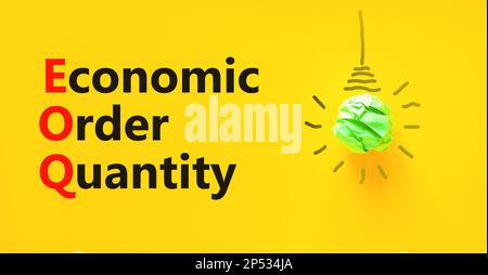 EOQ economic order quantity symbol. Concept words EOQ economic order quantity on paper on beautiful yellow background. Green light bulb icon. Business Stock Photo