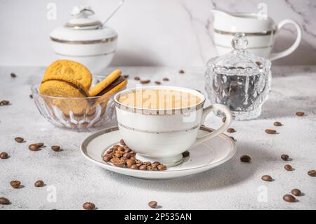 Coffee cup,coffee beans and sweets on the background Stock Photo