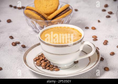Coffee cup,coffee beans and sweets on the background Stock Photo