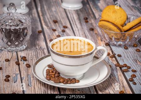 Coffee cup,coffee beans and sweets on the background Stock Photo