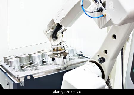 Robotic electronic arm and metal workpieces Stock Photo