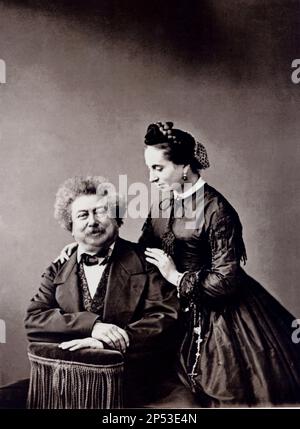 1865 ca , FRANCE : The french writer , poet and playwriter ALEXANDRE DUMAS father  (  père , padre ,  1802 - 1870  ) with the daughter MARIE-Alexandrine Dumas ( 1831 – 1878 ), daughter of Belle Krelsamer ( 1803 – 1875 ) . Author of books ' The Three Musketeers ' ( 1844 ,  I TRE MOSCHETTIERI ) and ' The Count of Monte Cristo ' (1844–1845 ,  IL CONTE DI MONTECRISTO ) . Portrait by Nadar , Paris  - POETA - POESIA - POETRY - COMMEDIOGRAFO - DRAMATIST - TEATRO - THEATER -  THEATRE - SCRITTORE - LETTERATO - LETTERATURA - LITERATURE - baffi - moustache  - collar - colletto - tie - cravatta papillon - Stock Photo