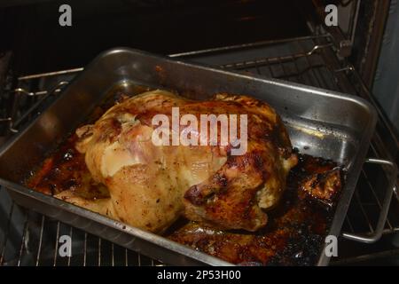 Close-up of a freshly roasted chicken while it is on the tray inside the oven Stock Photo