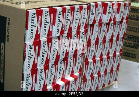 This July 29, 2013, photo shows a case of freshly-stamped Marlboro cigarette  cartons at M. Amundson Cigar & Candy Co. in Minneapolis. Minnesota's tax  increase on cigarettes has dampened sales since taking