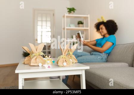 Smiling Black Woman Looking Family Photos On Easter Day Stock Photo