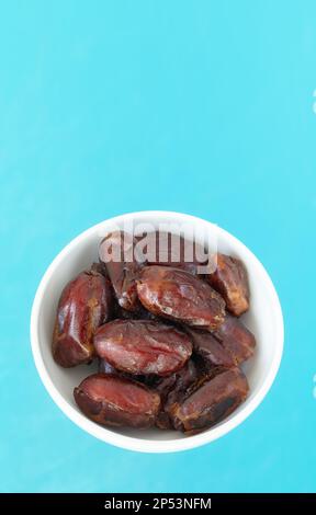 Close up picture of organic dates in a bowl, selective focus. Stock Photo