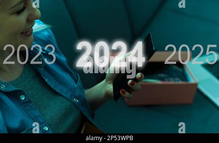 A man touching on virtual screen 2024. Business new year concept, welcome to year 2024 concept. Stock Photo