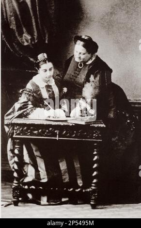 1850 ca, SPAIN : The Queen of Spain  MARIA CRISTINA  of Bourbon-Two Sicilies ( BORBONE delle Due Sicilie ,  1806 - 1878 ), married in Madrid 1829, to King of Spain Fernando VII ( 1784 - 1833 ). In this photo with her daughter Queen Maria ISABEL II Luisa of Spain ( Madrid 1830 - Paris 1904 ) , Queen from 1833 to 1868, deposed 30 september 1868, and abdicated 25 june 1870 . Married in Madrid 10 october 1846 her cousin, Infante prince  Francisco de Asis ( 1822 - 1902)-  REALI - royalty - nobili - nobiltà - ritratto - portrait - desk - scrivania - family - famiglia - madre e figlia - mother - REGI Stock Photo