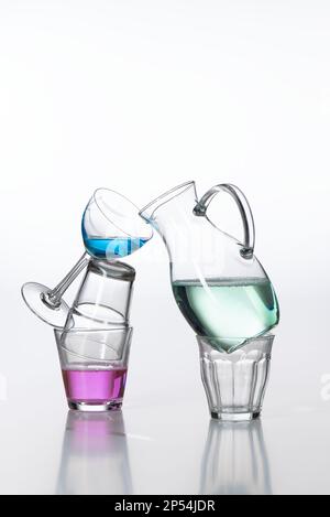 A still image from different shapes of glasses and vases, filled with colored water. Stock Photo