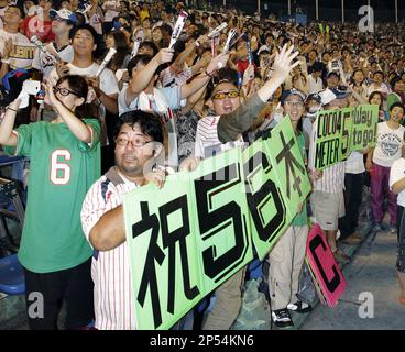 Fans of Hanshin Tigers celebrate as the team clinched their first