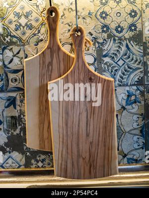 2 pcs wooden cutting board. Front view of cutting boards used and hung in the kitchen to dry Stock Photo