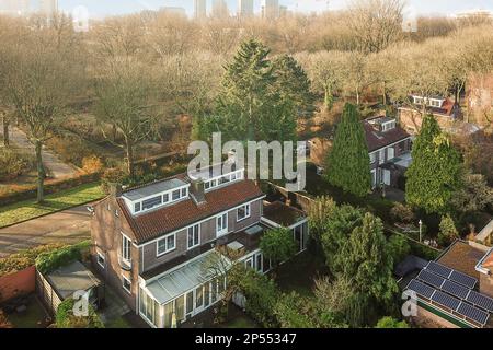 Amsterdam, Netherlands - 10 April, 2021: an aerial view of some houses in the city with trees and buildings on either side of the street, as seen from above Stock Photo
