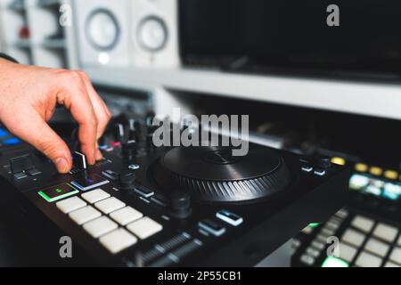 musician working on new music and mixing sounds in his home studio, closeup. High quality photo Stock Photo