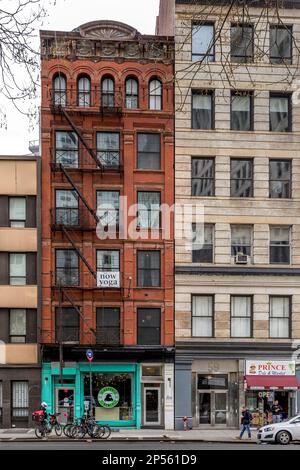 New York, USA - April 23, 2022: Typical New York City building with fire escape ladders Stock Photo