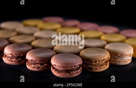 chocolate, coffee, vanilla, lemon and strawberry macaroons on black ...