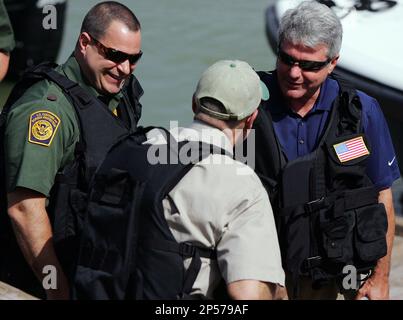 U.S. Border Patrol Chief Michael J. Fisher, left, and U.S. House Homeland  Security Chairman Michael McCaul, right, talk to Department of Public  Safety Director Steven McCraw, center, as they prepare to see