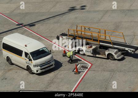 Baggage Loading Ramp Aircraft ramp loader loading baggage to conveyor belt on airport apron ...