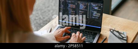 Close up of woman freelance programer working on laptop while sitting in cafe. Data done right Stock Photo
