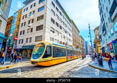 MILAN, ITALY - APRIL 11, 2022: Tram on Via Torino stree, one of the main shopping areas in central district, on April 11 in Milan, Italy Stock Photo