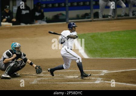 MILWAUKEE, WI - SEPTEMBER 23: Nyjer Morgan #2 of the Milwaukee Brewers  celebrates the division tittle in the locker room with Yuniesky Betancourt  #3 after the game against the Florida Marlins at