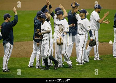 MILWAUKEE, WI - SEPTEMBER 23: Nyjer Morgan #2 of the Milwaukee Brewers  celebrates the division tittle in the locker room with Yuniesky Betancourt  #3 after the game against the Florida Marlins at